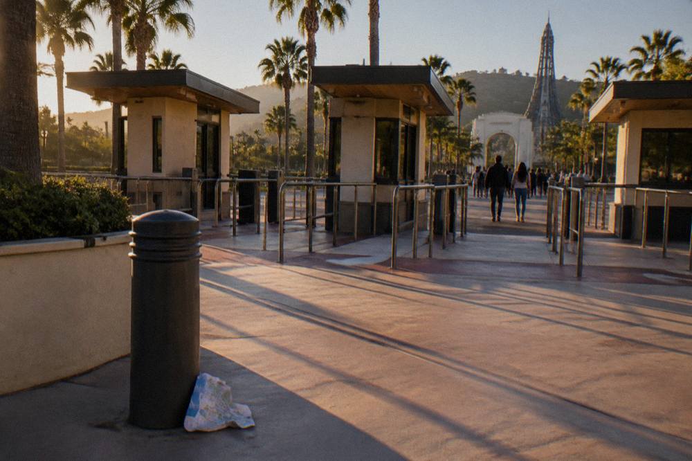 Ticket booths and entry gates of a theme park under late afternoon sun