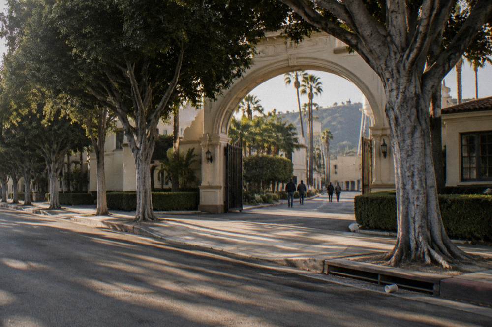 The arched Paramount studio gate seen from the sidewalk on Melrose Avenue