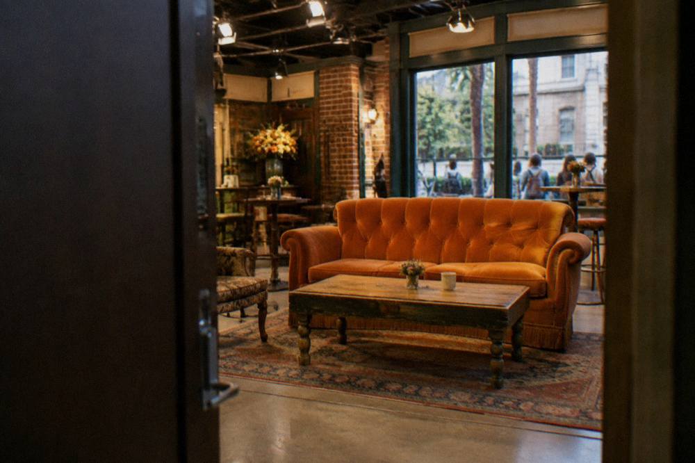 Central Perk café set with orange couch and window storefront inside a studio exhibit hall