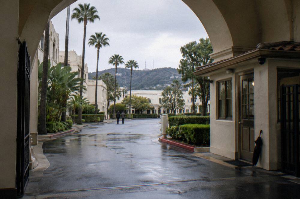 Historic studio archway gate with security booth at a Los Angeles film lot entrance