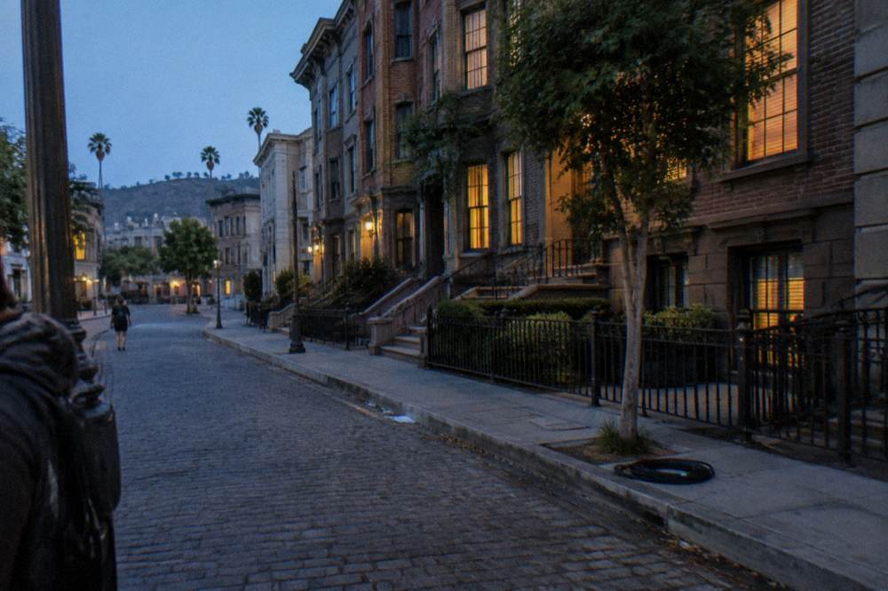 New York style brownstone facades lining a studio backlot street in Los Angeles