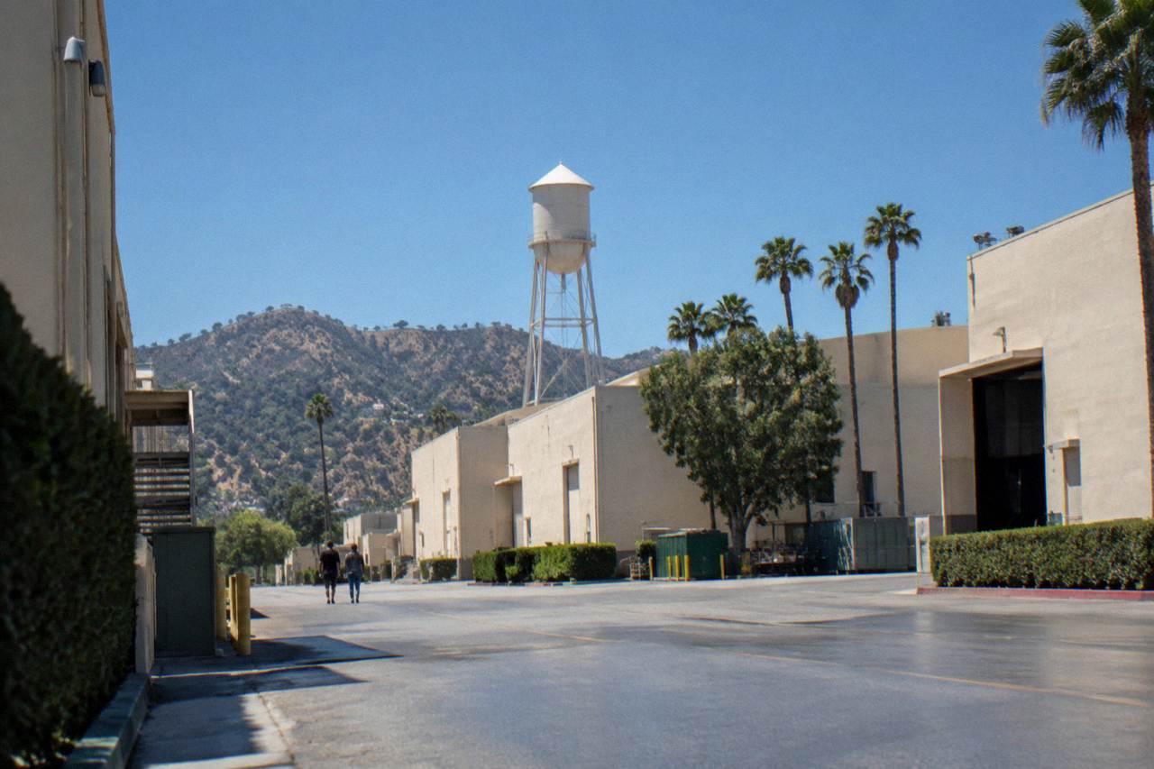 Studio soundstages and water tower on a Los Angeles movie lot under a clear sky