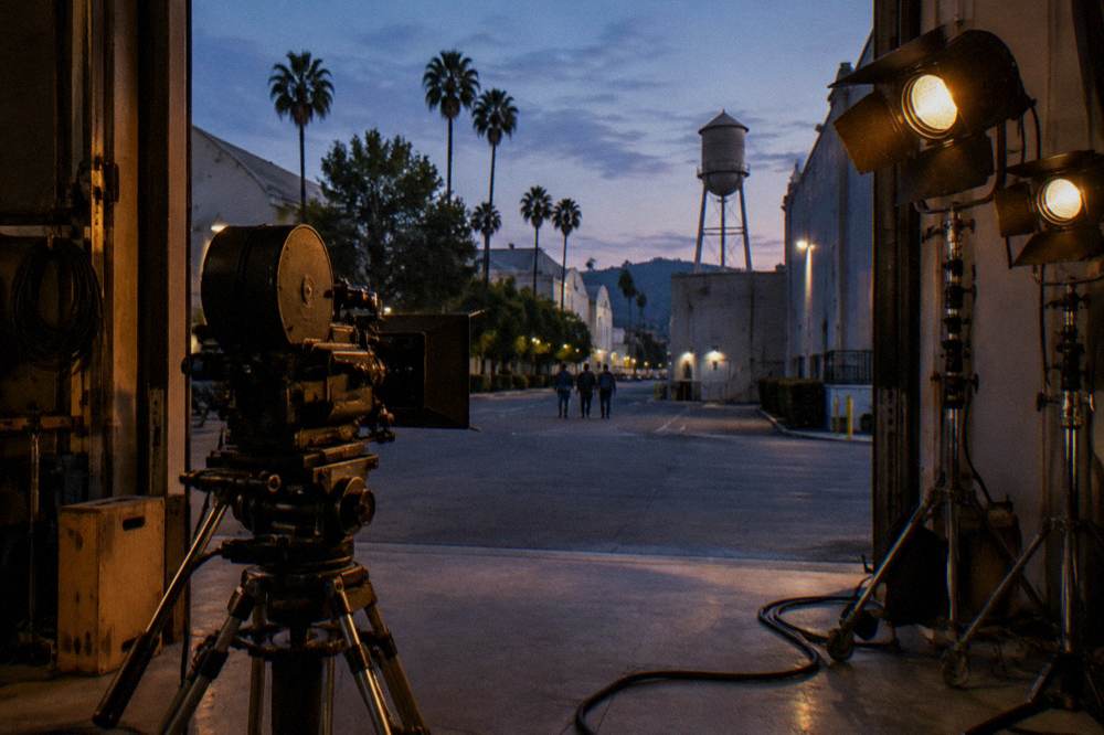 Vintage film camera and lighting equipment arranged inside a studio stage doorway