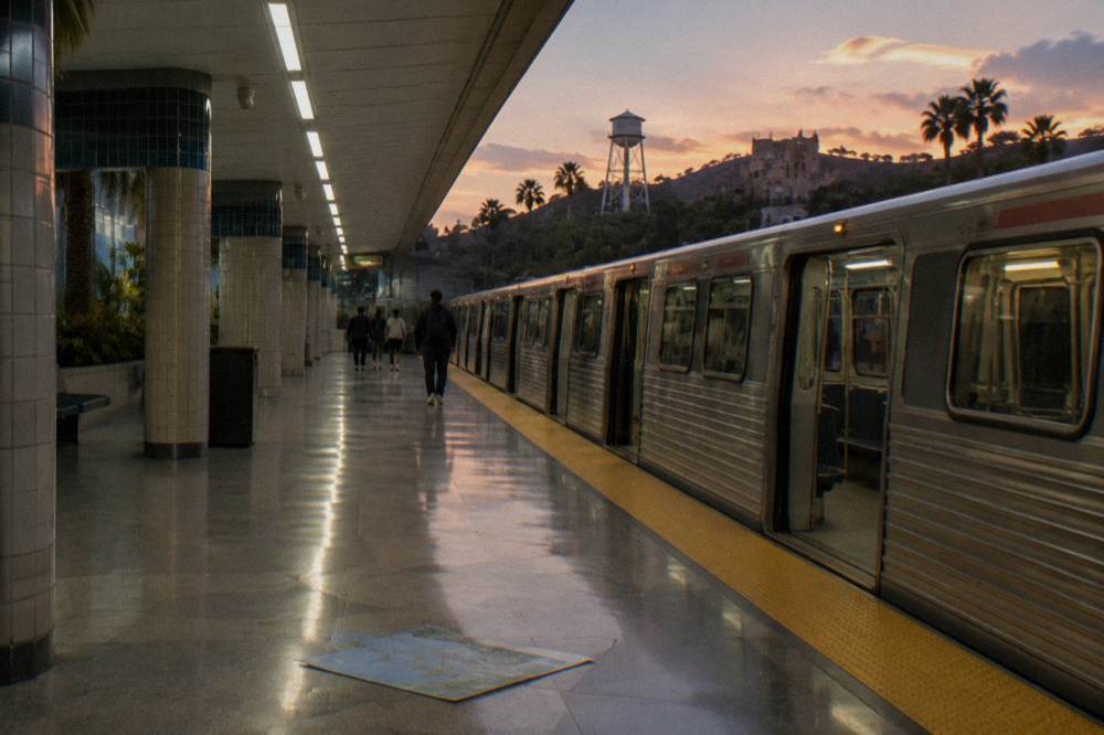 Modern subway platform with a waiting train and wayfinding signs under bright ceiling lights