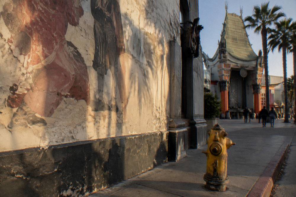 The exterior of a vintage Hollywood music venue with a painted mural wall