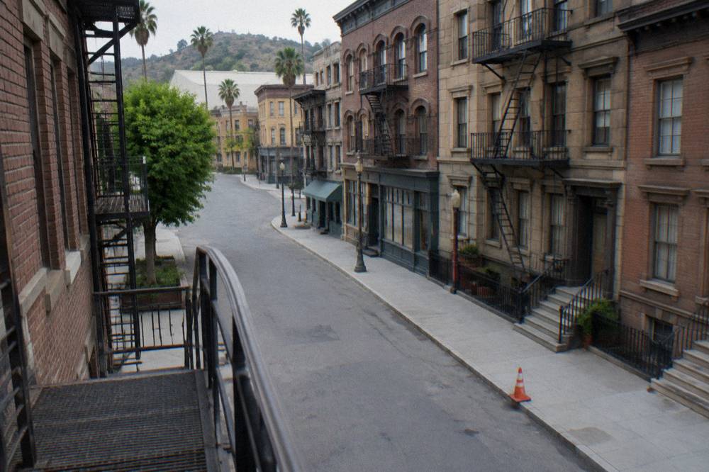 Standing New York street backlot facades under clear sky on a studio lot