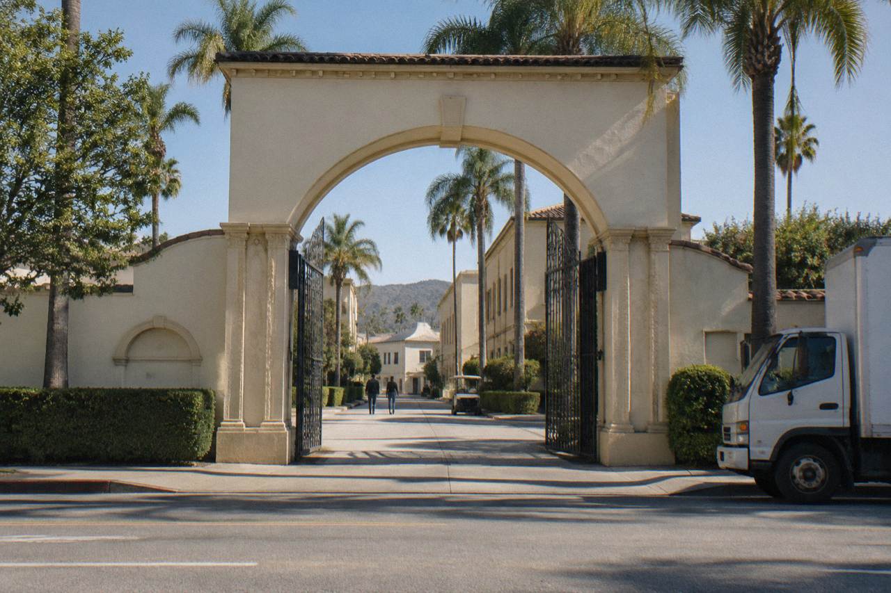 The historic Bronson Gate archway at the Paramount Pictures studio lot in Hollywood on a clear afternoon