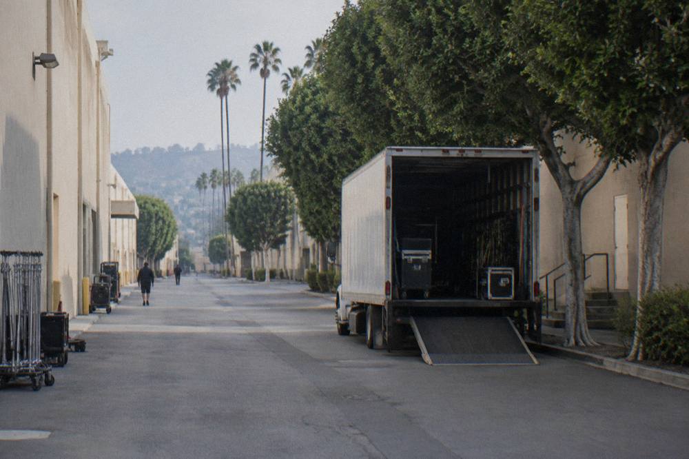 A sunny studio backlot street lined with production buildings