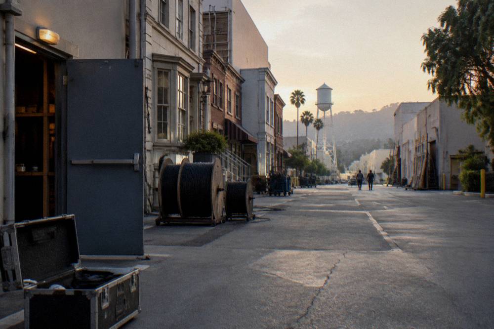A studio backlot street with facades and production equipment