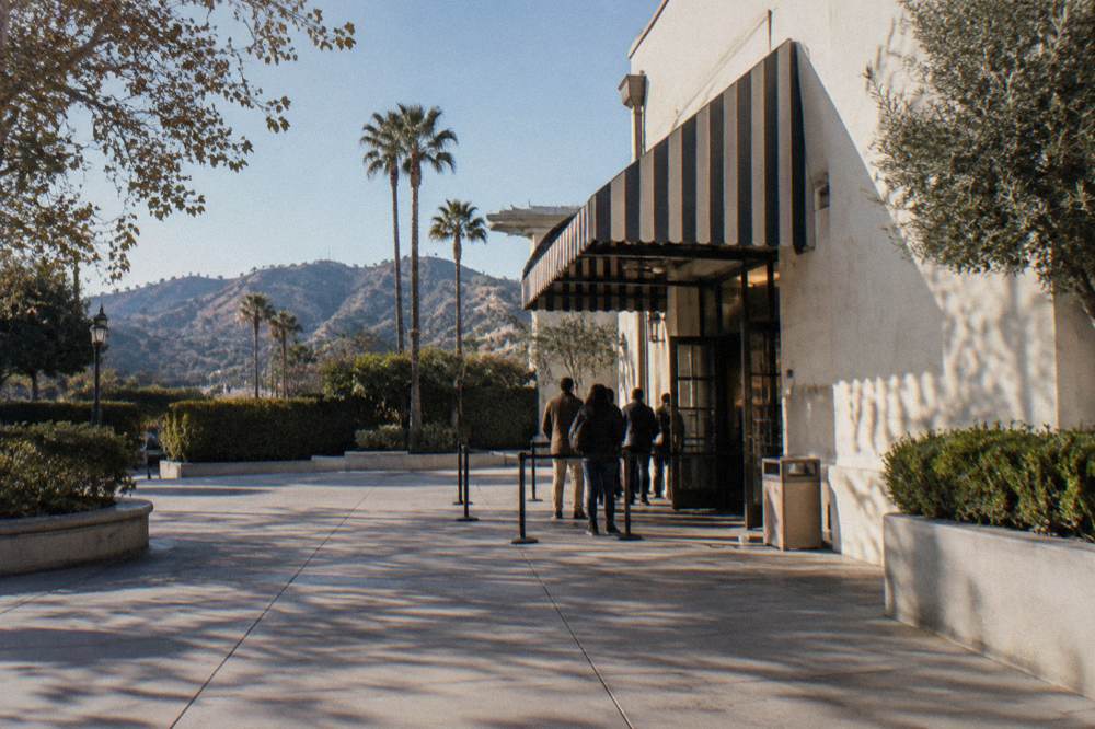 Studio tour welcome center entrance with awning and directional signage