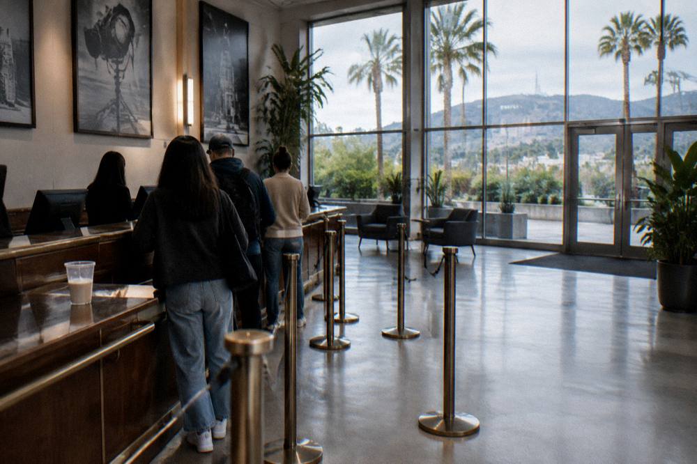 Ticketing desk and queue area inside a bright studio tour lobby